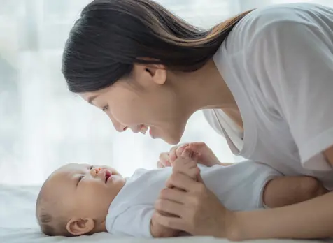Mum playing with baby, promoting early play, learning, and development for babies