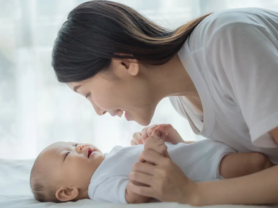 Mum playing with baby, promoting early play, learning, and development for babies