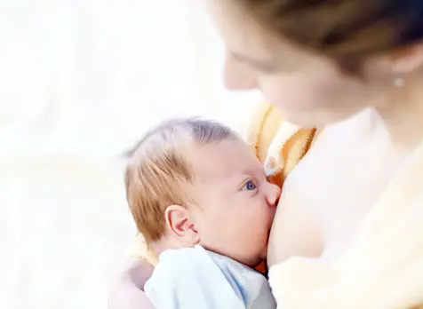 Mother breastfeeding baby, featured on baby feeding advice and breastfeeding support page