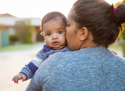 Mum kissing baby featured on baby health and wellbeing support page