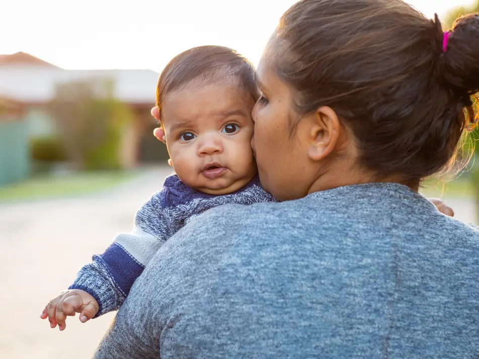 Mum kissing baby featured on baby health and wellbeing support page