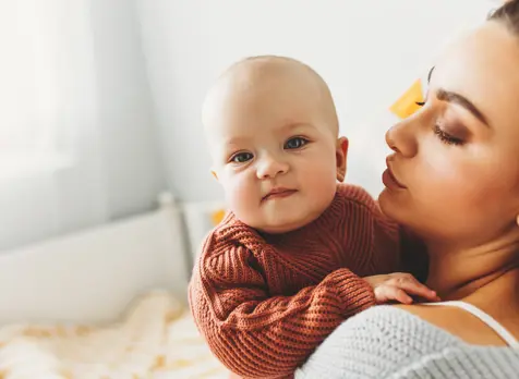 Mum caring for newborn, featured on page with newborn parenting tips and expert guidance